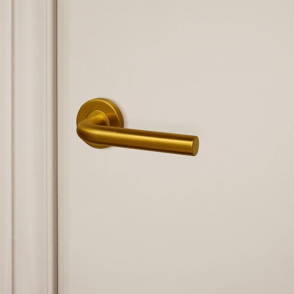 Oristano door handle matt gold PVD coated with round rosette